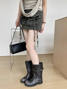 Vintage buckle slouchy boots detail showcasing unique retro fold design and metallic hardware accents.