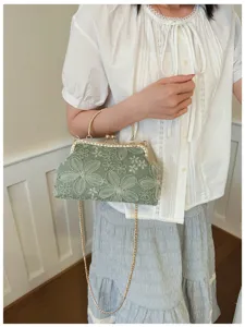 Green embroidered lace clasp evening handbag with gold chain handle and chic floral detail.