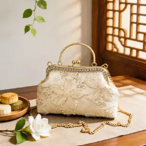 Elegant Chinese style embroidered evening bag with kiss-lock closure and gold chain.