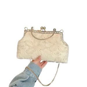 Elegant embroidered evening bag with rhinestone clasp and chain strap for women parties.