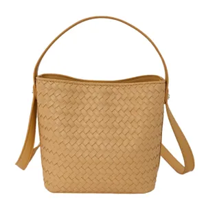 Woven leather bucket bag detail showing soft texture, top handle and strap.