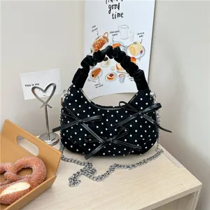 Korean style black polka dot handbag with bow decoration, chain strap and cute shoulder bag design.