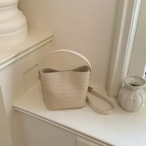 Casual woven leather bucket bag, stylish crossbody shoulder bag for women daily use.