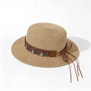 Exquisite flat top straw hat detail showing ethnic woven band and leather bow.
