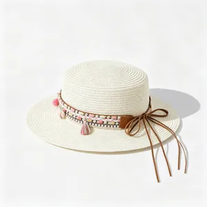 Closeup view of a flat top straw hat featuring boho woven band and elegant brown ribbon detail.