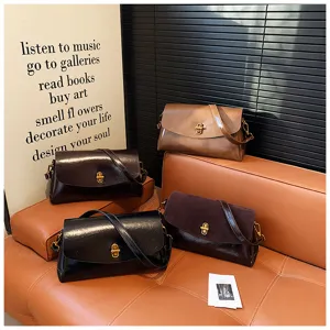 Detail view of stylish PU leather shoulder bag with metal lock and adjustable strap.