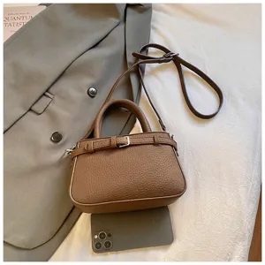 Vintage brown leather crossbody bag with top handle and adjustable strap for women casual daily use.
