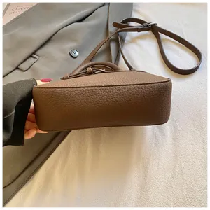 Vintage brown leather crossbody shoulder bag with top handle and adjustable strap for daily use.
