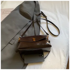 Dark brown leather shoulder bag for women, stylish crossbody bag with metal lock detail.