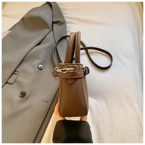 Detailed view of brown retro textured crossbody bag, lightweight stylish mini square handbag.