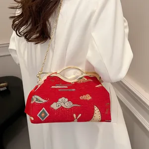 Chinese style embroidered handbag for women, elegant evening crossbody bag with metal handle.
