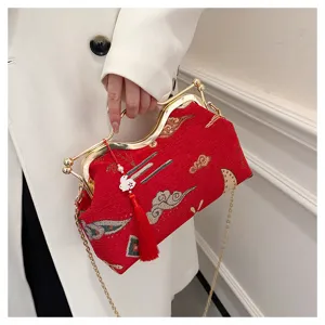 Chinese style red embroidered evening handbag with gold frame, tassel and chain strap.