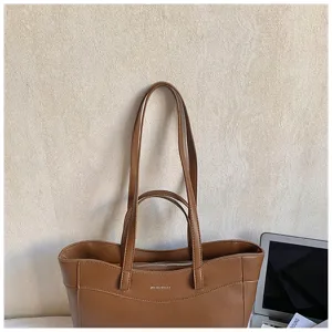 Brown PU leather tote bag detail showcasing smooth texture, double handles and clean stitching.