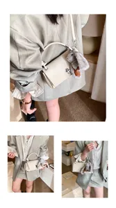 Detailed view of the chic frosted crossbody bag featuring a soft plush rabbit pendant charm.