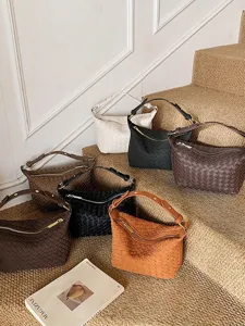 Woven leather crescent shoulder bag, stylish retro dumpling crossbody bag for daily women.