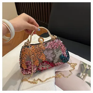Sequin evening clutch bag with metal handle, pearl clasp, and chain strap for women.
