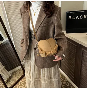 Stylish suede heart-shaped crossbody shoulder bag with ruched strap detail for daily wear.