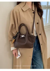 Stylish dark brown leather tote bag for women, featuring metal clasp and chic retro minimalist design.