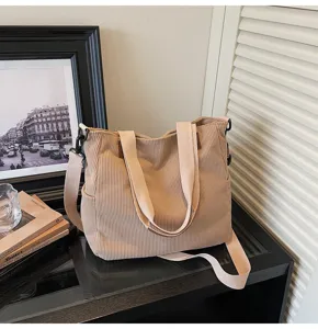 Detail view of a beige corduroy tote shoulder bag with sturdy straps and casual style.