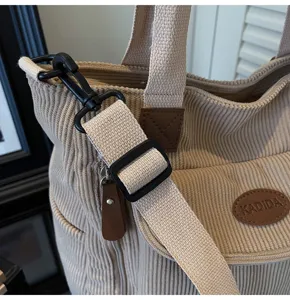 Casual corduroy tote bag for women, stylish shoulder handbag with adjustable strap and chic patch.