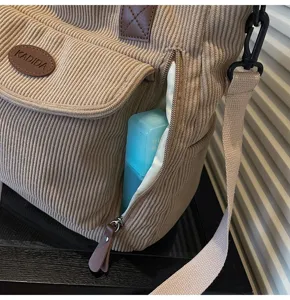 Casual corduroy shoulder bag women daily tote commuting handbag with front pocket and zipper.