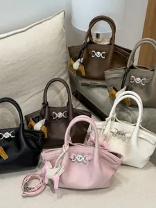 Chic solid color women handbag PU leather tote bag with stylish hardware and pendant.