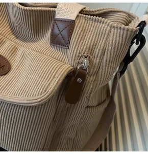 Casual corduroy tote bag for women, retro shoulder bag with zipper and front pocket details.