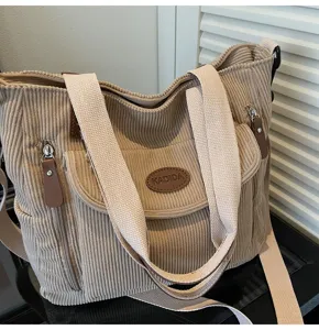 Casual corduroy tote bag for women, stylish shoulder handbag with zipper and pockets.