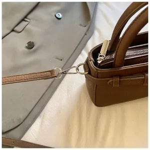 Brown retro women crossbody handbag detail showing metal zipper and strap hardware.