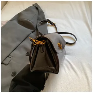Stylish glossy leather crossbody bag for women, chic commuter shoulder bag, casual fashion.