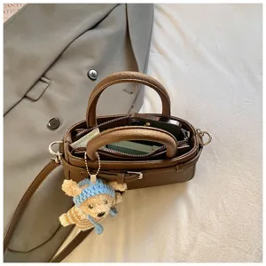 Retro brown small crossbody bag for women, fashion PU leather handbag with cute bear pendant.