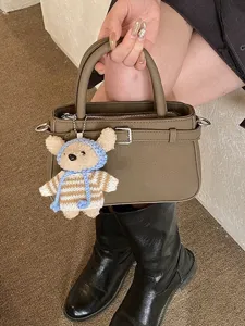 Retro versatile small crossbody bag with stylish belt detail and cute bear pendant.