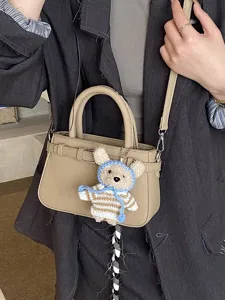 Retro versatile crossbody bag with cute bear pendant, stylish top handle shoulder bag for women.
