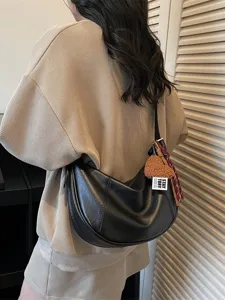 Retro black hobo shoulder bag for women, stylish crescent crossbody purse with pendant.