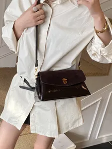 Chic glossy women's shoulder bag with metallic lock, elegant crossbody daily purse.