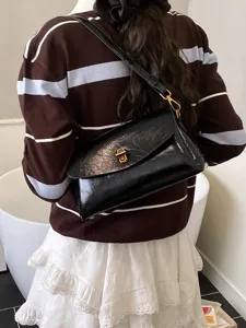 Stylish black patent leather shoulder bag for women, retro crossbody bag with metal lock.