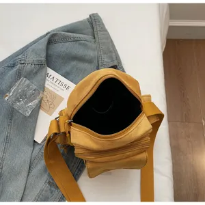 Crossbody camera bag for women, stylish casual messenger bag with wide shoulder strap and pockets.