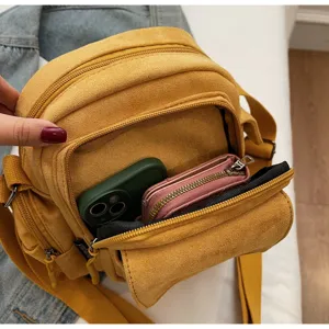 Yellow suede crossbody camera bag with multiple zipper compartments for women daily outdoor use.