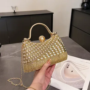 Elegant gold rhinestone evening clutch bag with metallic top handle and chain strap for women.