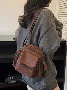 Brown vintage casual crossbody bag, stylish multi-pocket canvas shoulder bag for daily use.