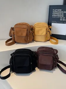 Multi-pocket canvas crossbody bag, versatile casual messenger bag for women stylish daily use.