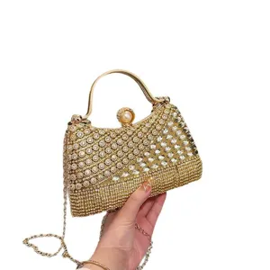 Elegant gold rhinestone evening bag with chain strap and pearl clasp for women parties.