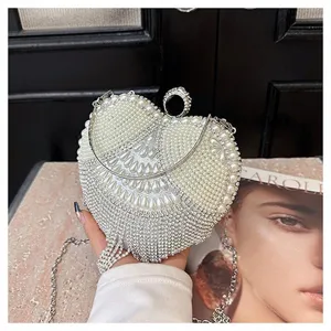 Stunning rhinestone and pearl heart evening bag detail, sparkling crystal clutch for party.