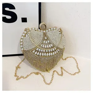 Stunning heart-shaped evening bag with pearl and rhinestone embellishments, gold chain.