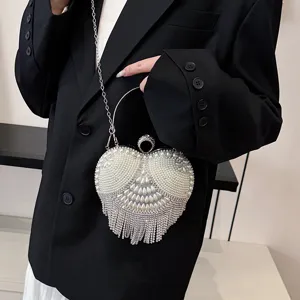 Elegant heart-shaped evening bag with pearls, rhinestones, metal handle and strap for women.