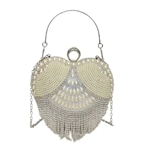 Heart-shaped pearl rhinestone evening bag clutch with metal ring handle and chain.