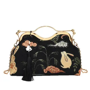 Chinese style embroidered rabbit clutch bag, black tapestry fabric handbag with gold frame.
