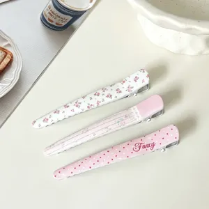 Detail shot of sweet floral and polka dot duckbill hair clips, stylish sweet hair accessories.