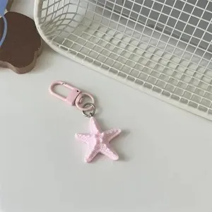 Cute pink starfish keychain bag pendant, perfect accessory for keys and daily outfits.