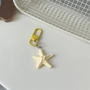 Cute 3D starfish keychain variant, yellow metal clasp and cream pendant, versatile bag charm.